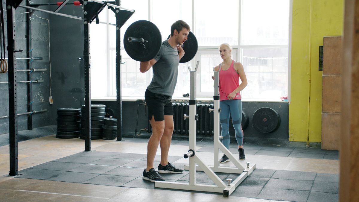 Two athletes training together and checking a phone